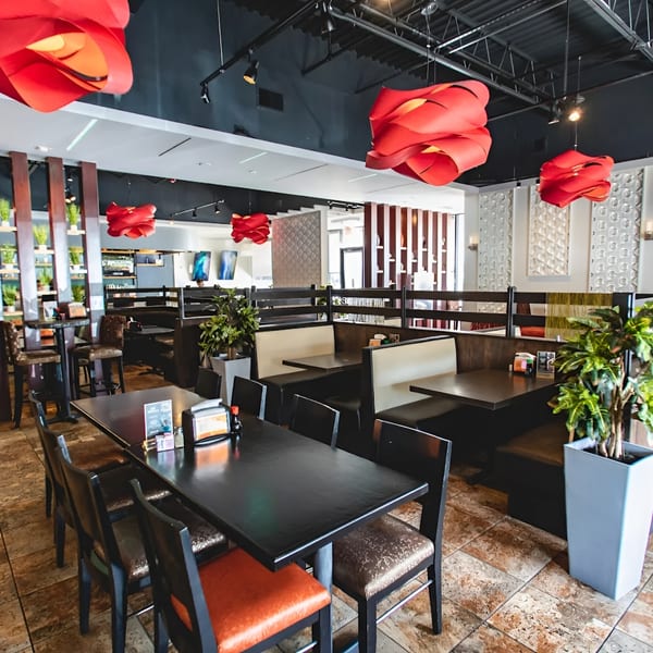 Zake's modern Asian-fusion dining room features red light fixtures, dark tables, and booth seating.